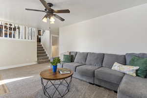 Living room with ceiling fan and carpet flooring