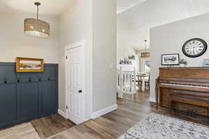 Foyer with lofted ceiling, a textured ceiling, and hardwood / wood-style floors