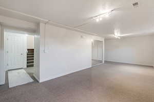 Family room with a mirrored closet wraps around to the storage/hobby room