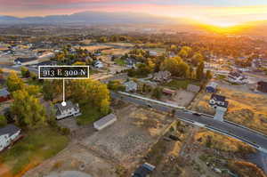 Aerial view of the house and pasture at dusk with a mountain view looking west