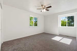 3rd upstairs bedroom with a healthy amount of sunlight, and a ceiling fan