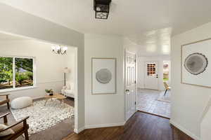 Entryway featuring a coat closet, and hardwood flooring, adjacent to the front sitting room