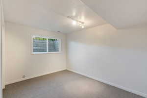 4th bedroom/office with a textured ceiling and rail lighting