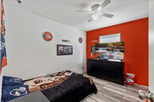 Bedroom featuring light hardwood / wood-style flooring and ceiling fan