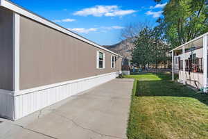 View of yard with a mountain view and a patio area