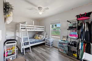 Bedroom with ceiling fan and dark hardwood / wood-style floors