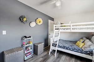 Bedroom with ceiling fan and hardwood / wood-style flooring