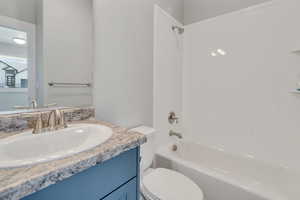 Full bathroom featuring vanity, bathing tub / shower combination, and toilet