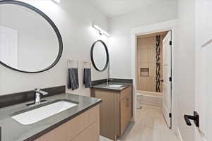 Full bathroom featuring tiled shower / Double Sinks