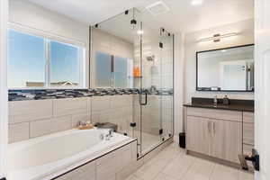 Bathroom with vanity, plus walk in shower, and tile patterned flooring