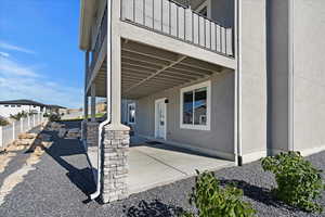 Doorway to property featuring a balcony and a patio area