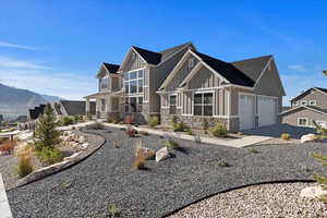 Craftsman-style house featuring a mountain view and a garage