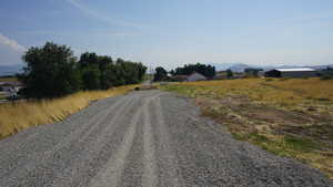 View of dirt / gravel road featuring a mountain view
