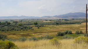 View of mountain background featuring rural landscape