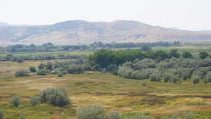 View of mountain background featuring rural landscape