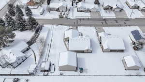 Snowy aerial view featuring a residential view