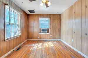 Living area with wood-type flooring and a healthy amount of sunlight