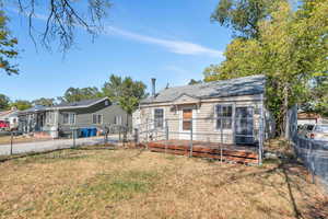 View of front of home featuring a deck and a front yard