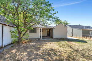 Rear view of property with a yard