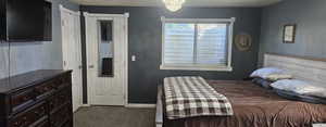 Bedroom featuring a textured ceiling and dark colored carpet