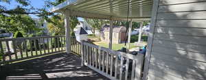 Deck featuring a shed