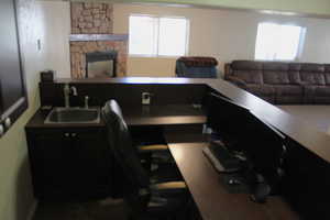 Home office with a stone fireplace and sink