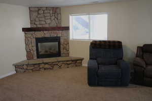 Carpeted living room featuring a fireplace