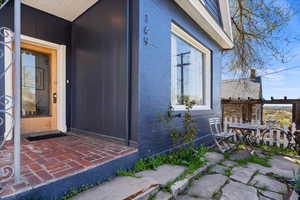 Doorway to property featuring a patio