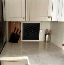 Interior details with white cabinets and concrete floors