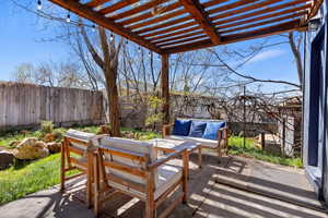 View of patio featuring an outdoor hangout area and a pergola