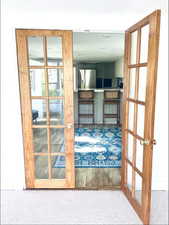 Entryway featuring carpet and french doors