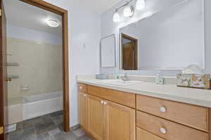 Bathroom with vanity and bathtub / shower combination