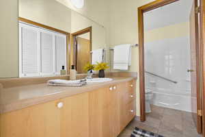 Full bathroom featuring tile patterned floors, shower / bath combination, vanity, and toilet