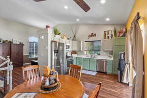 Dining room featuring a healthy amount of sunlight, lofted ceiling, dark hardwood / wood-style floors, and sink