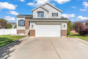 View of front of home featuring a garage and a front lawn