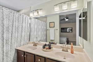 Bathroom featuring ceiling fan and vanity