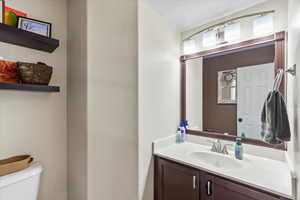 Bathroom featuring vanity and toilet