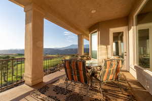 View of patio with a balcony and a mountain view