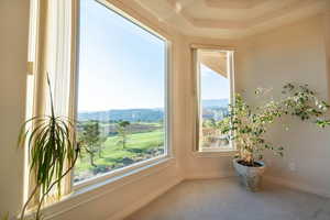 Interior space with carpet and a mountain view