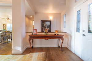 Foyer with ceiling fan and light wood-type flooring