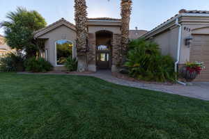 Mediterranean / spanish-style home with a front lawn and a garage