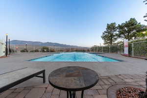 View of pool with a patio and a mountain view