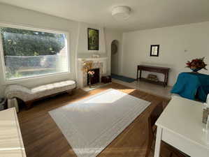 Living room featuring a tile fireplace and hardwood / wood-style floors