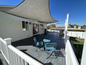 Wooden terrace featuring a grill