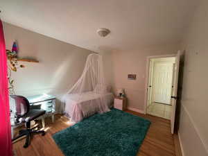 Bedroom with hardwood / wood-style flooring