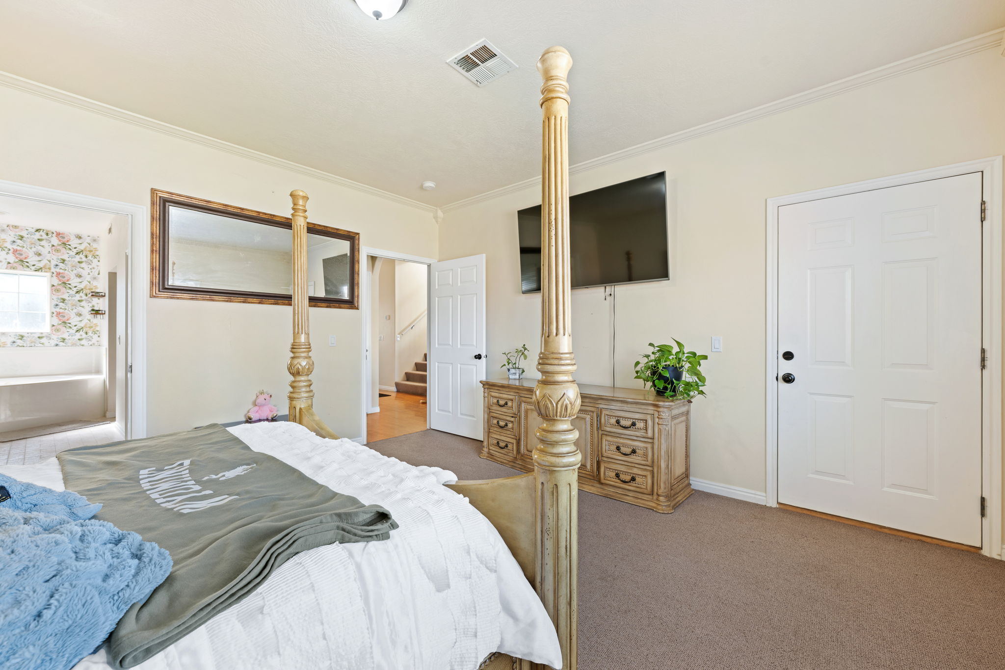 Bedroom with ornamental molding and carpet