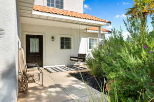 Doorway to property featuring a patio