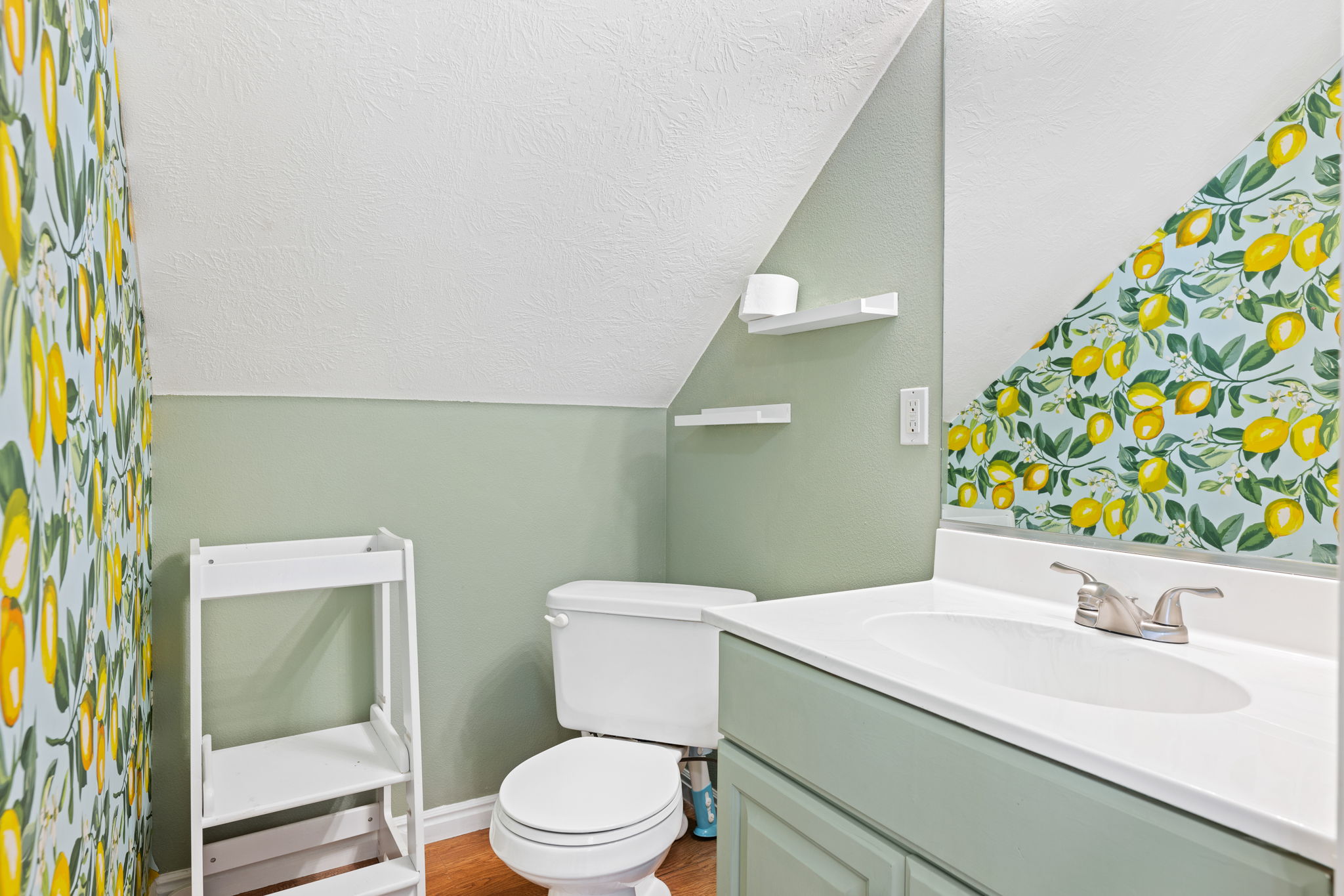 1/2 Bathroom featuring wood-type flooring, vanity, and toilet
