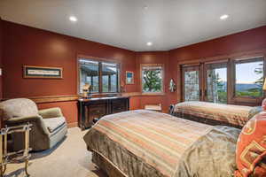 Carpeted bedroom featuring french doors