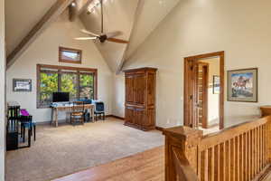 Office space with high vaulted ceiling, beam ceiling, ceiling fan, and light hardwood / wood-style flooring